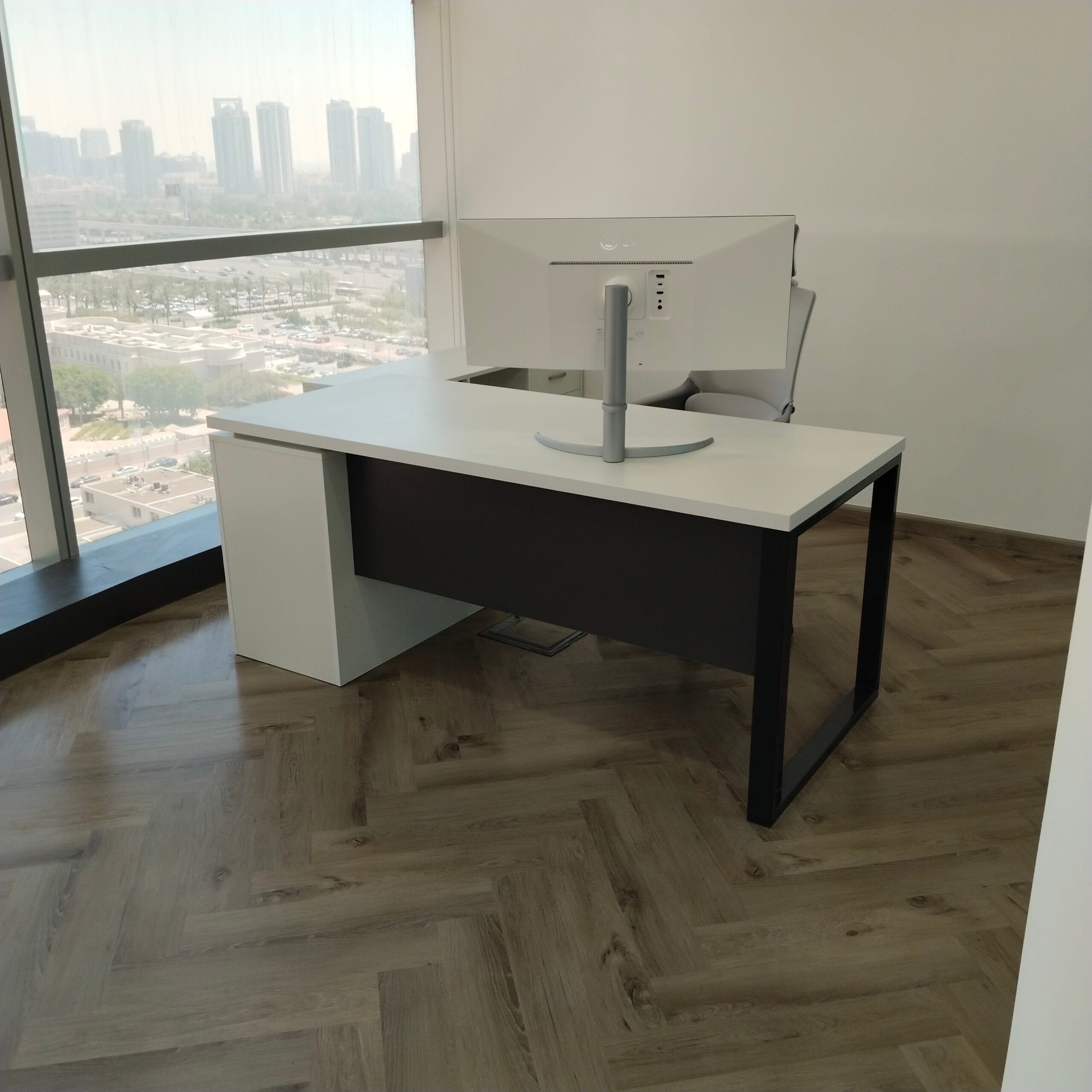 Finished office fit-out with herringbone wood-look flooring installed by Zale Interior in Dubai