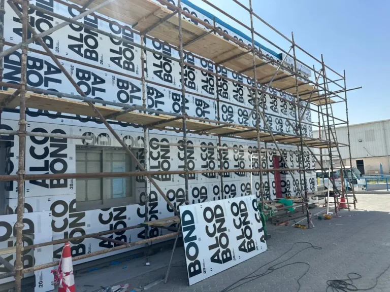 ACP cladding panels being installed on a building facade