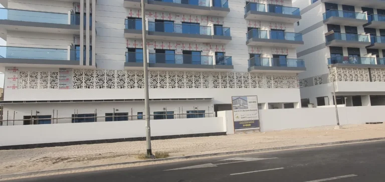 Perforated ACP panels and glass balcony railings on an apartment building
